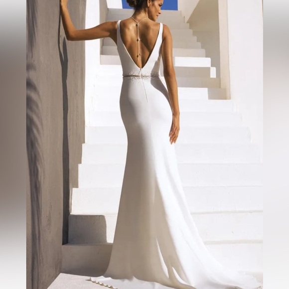 Pronovias Alaia is a striking crepe wedding dress featuring linear beading. - Picture 2 of 11